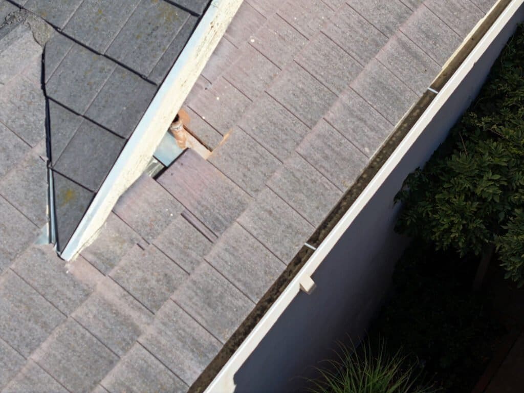 San Diego roof inspection shows loose tile sliding down that could fall off roof from two stories high.